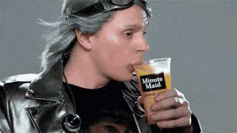 a man in a leather jacket is drinking a cup of minute maid orange juice .