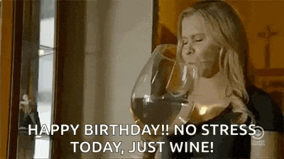 a woman is drinking a glass of wine from a large glass .