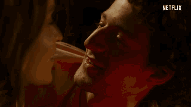 a close up of a man and woman kissing with netflix written on the bottom