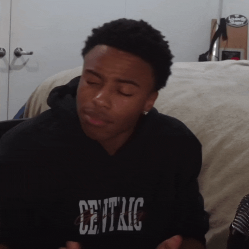 a young man wearing a black sweatshirt with the word central on the front