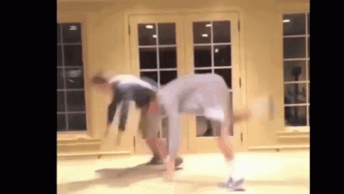 a man is doing a handstand in a living room .
