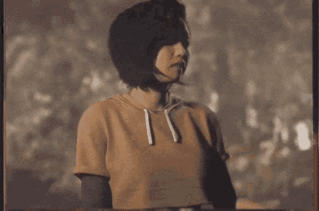 a woman in a hoodie is making a funny face