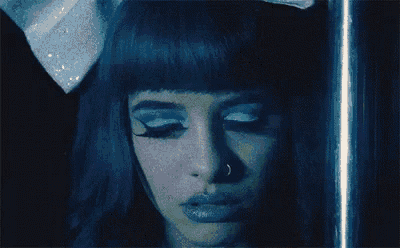 a close up of a woman 's face with a nose ring