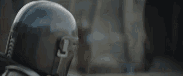 a close up of a person wearing a helmet with a l on it
