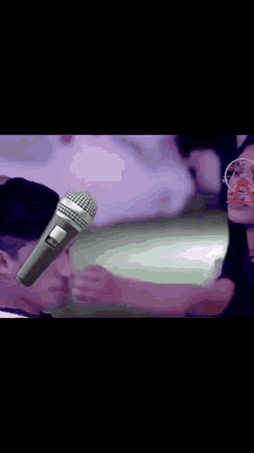 a microphone is sitting on a table next to a woman