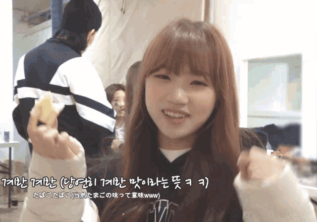 a girl with korean writing on her face holds a donut