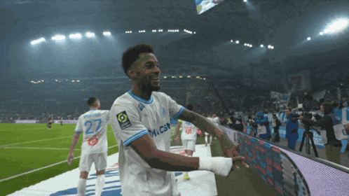 a soccer player wearing a white shirt with the number 27 on it