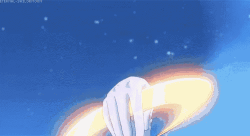 a person is holding a ring in their hand in a blue sky .