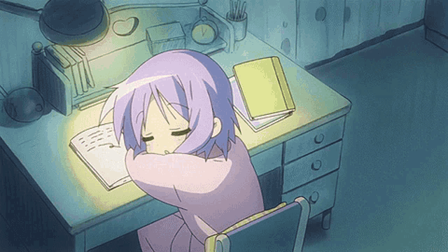 a girl with purple hair sits at a desk with a book on it
