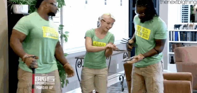 a group of people wearing green shirts that say yard wars