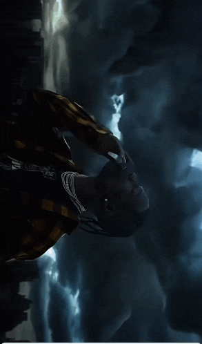 a person laying down with their eyes closed and smoke coming out their mouth