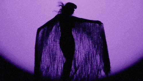 a silhouette of a woman in a purple dress