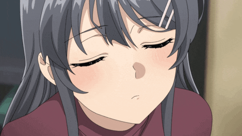 a close up of a girl 's face with a sad look on her face
