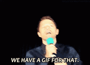 a man is holding a microphone and saying we have a gif for that ..