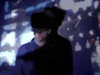 a silhouette of a man standing in front of a wall with a blurred background .