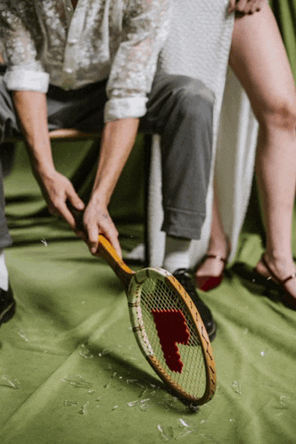 a tennis racquet with a heart painted on it