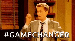 a man in a suit and tie is standing in a room with his fist in the air and says `` gamechanger '' .
