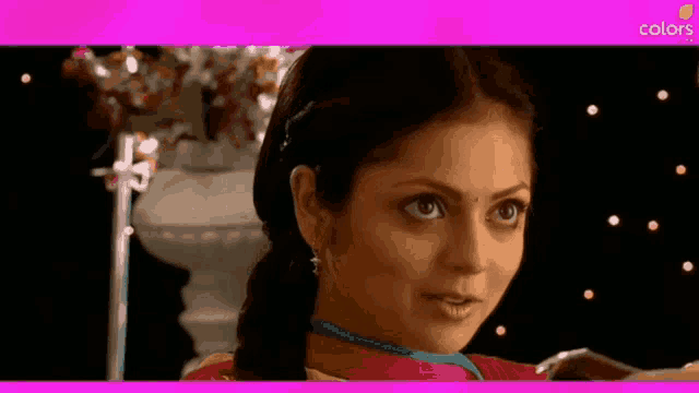 a close up of a woman 's face with a pink border that says colors