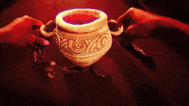 a painting of two hands holding a cup with a spiral design on it