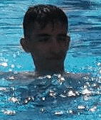 a man is swimming in a swimming pool .