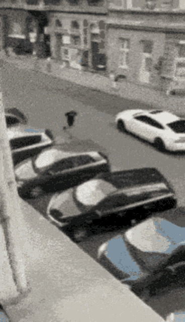 a row of cars parked on the side of a street