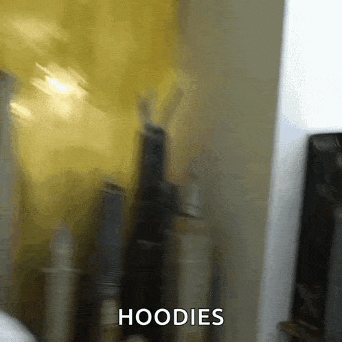 a blurry picture of bottles with the word hoodies written on the bottom