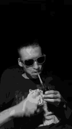 a black and white photo of a man smoking a pipe with the words smoka time written in blue
