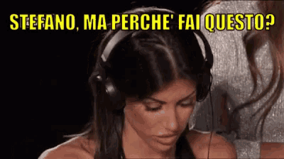 a woman wearing headphones says stefano ma perche ' aiquesto '