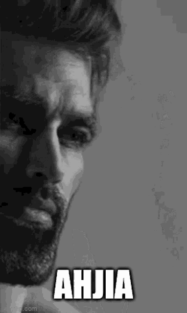 a black and white photo of a man with a beard and the words ahjia written on it .