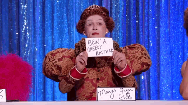 a woman in a costume is holding a sign that says bein ' a greedy bastard