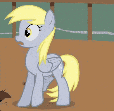 a pony with a yellow mane and tail is standing on a dirt field