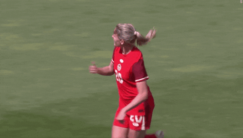 a female soccer player wearing a red jersey with the number 20 on it
