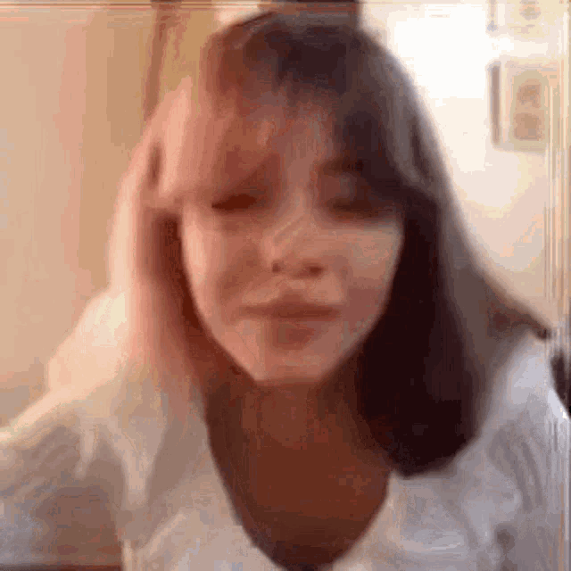 a close up of a girl 's face with a blurred background .