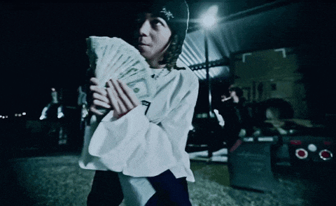 a person holding a fan of money with the number 7 on the front