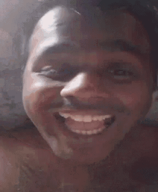 a man without a shirt is smiling for the camera