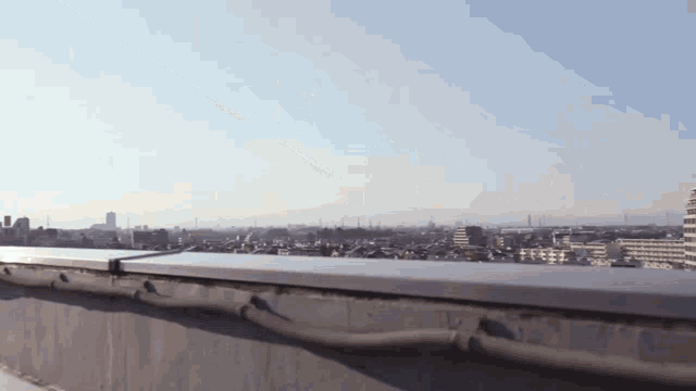 a view of a city from a rooftop with a blue sky