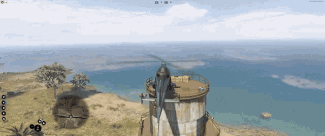 a helicopter is sitting on top of a tower near the ocean