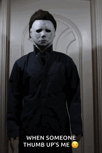 a man in a mask is standing in front of a door and says when someone thumb up 's me