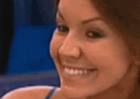 a woman is smiling and looking at the camera