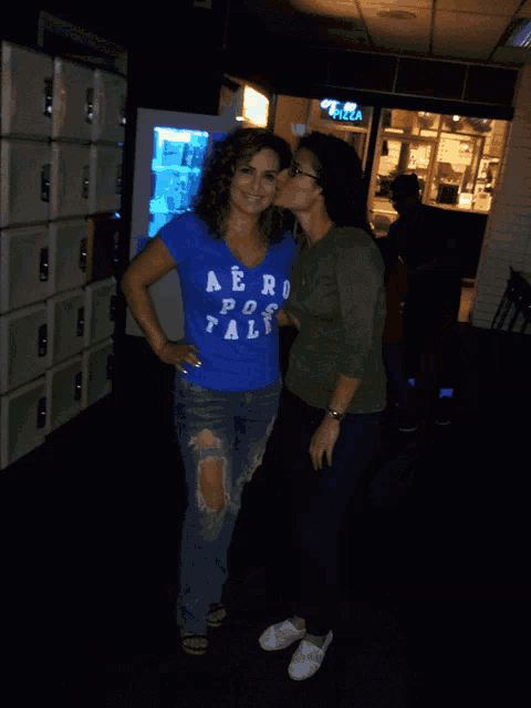 two women are posing for a picture and one is wearing a blue aeropostale shirt