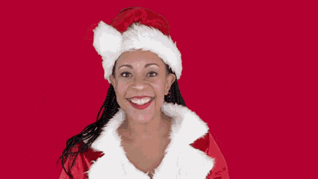 a woman dressed in a santa claus costume with her hands in the air