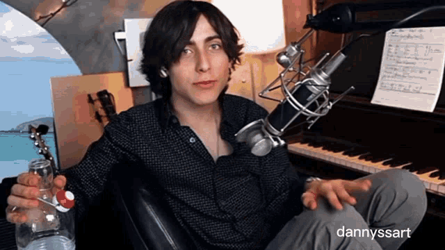a man is sitting in front of a microphone with the name dannyssart on the bottom
