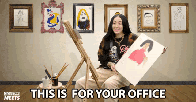 a woman holding a painting with the words this is for your office below her