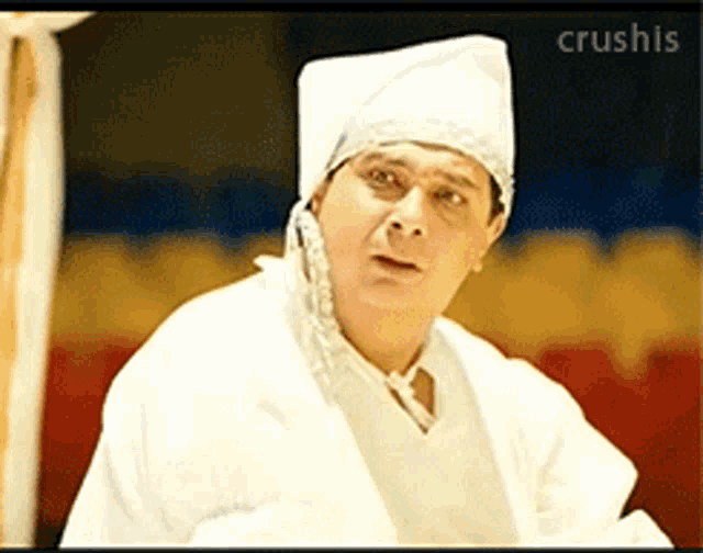 a man wearing a white hat and a white robe with the word crushis on the bottom