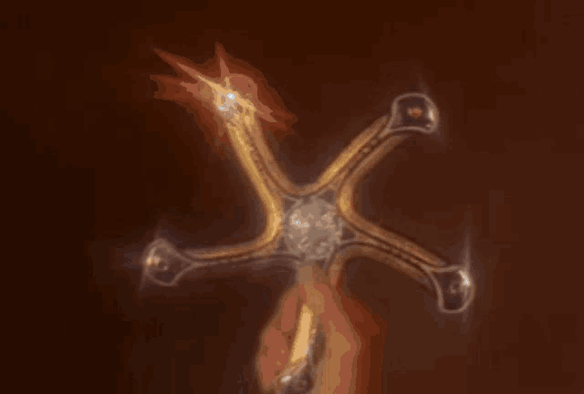 a person is holding a cross in their hand
