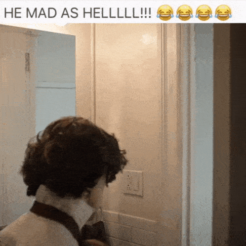 a man standing in front of a door with a caption that says he mad as hell