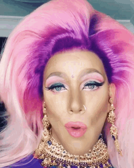 a close up of a drag queen with purple hair
