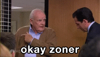 a man pointing at another man with the words okay zoner written on the bottom