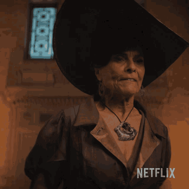 a woman wearing a hat and a necklace with a netflix logo in the corner