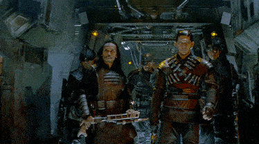 a group of soldiers are walking down a hallway and one of them is holding a gun